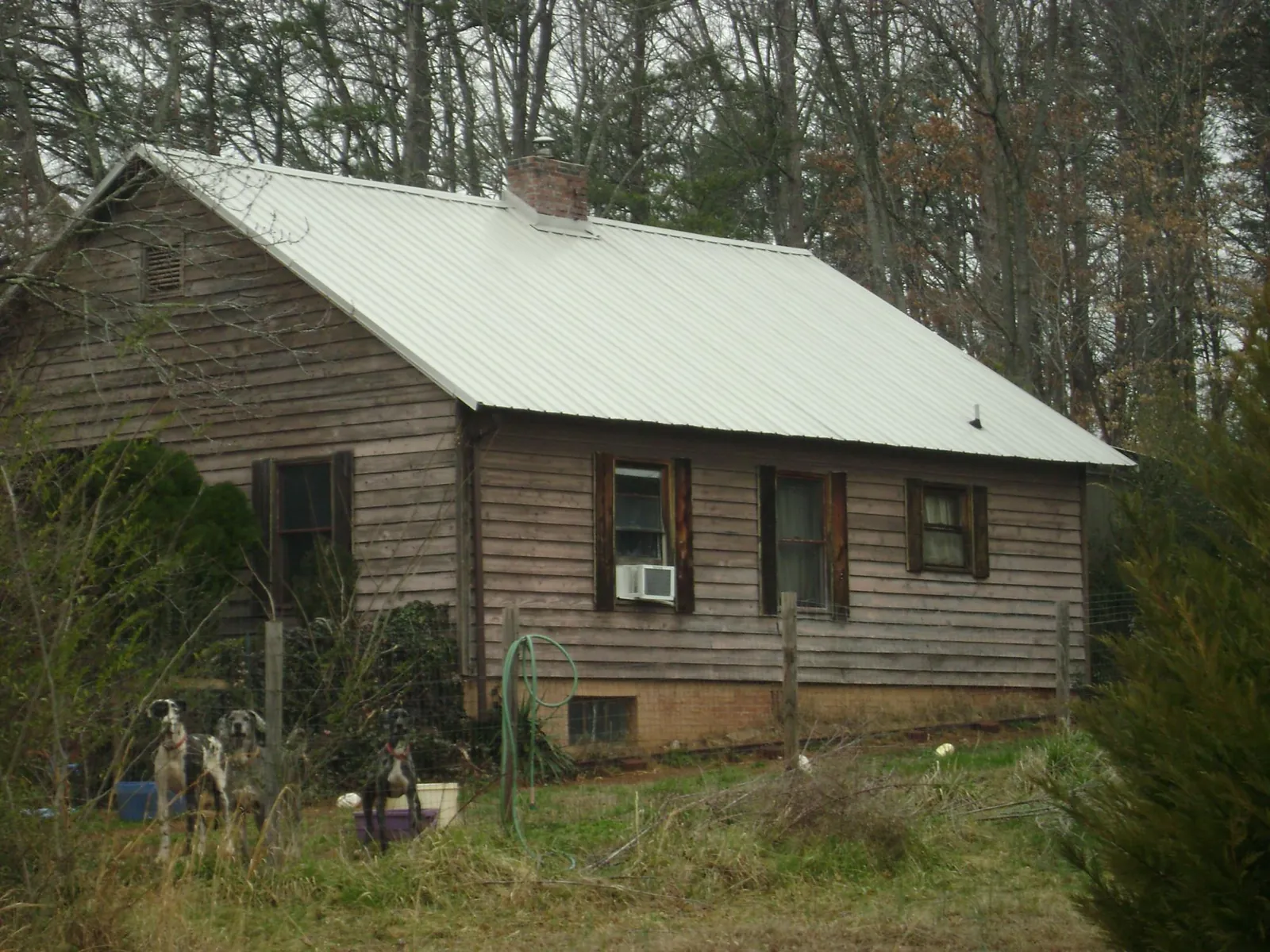 White metal roof on an old wood sided farmhouse, from a Metal Roof Installation job in Hamden